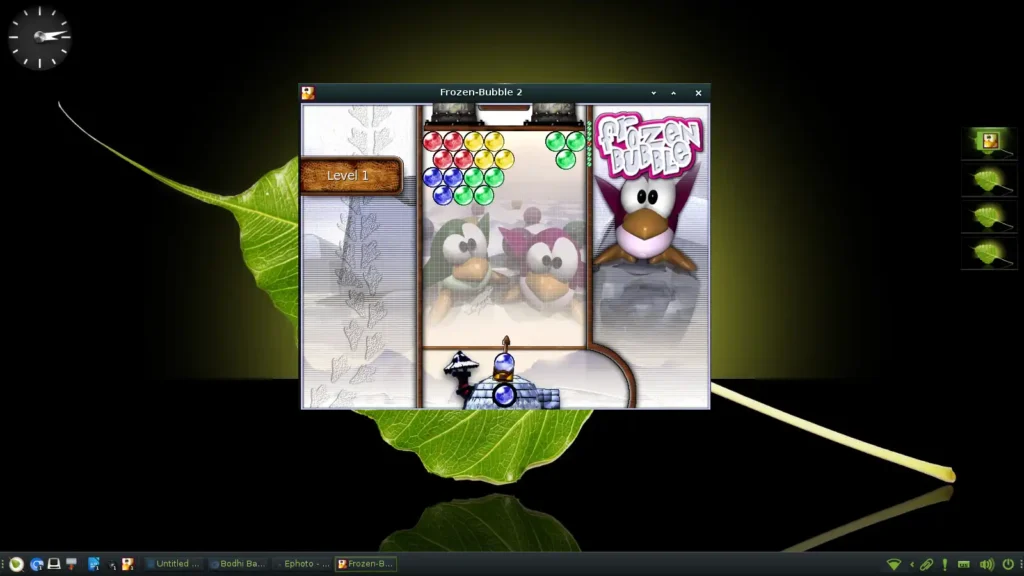 Screenshot of a computer game, Frozen Bubble, being played on a Bodhi Linux computer. The game features cute penguins and an igloo. The goal of the game is to shoot colored bubbles at other bubbles of the same color.